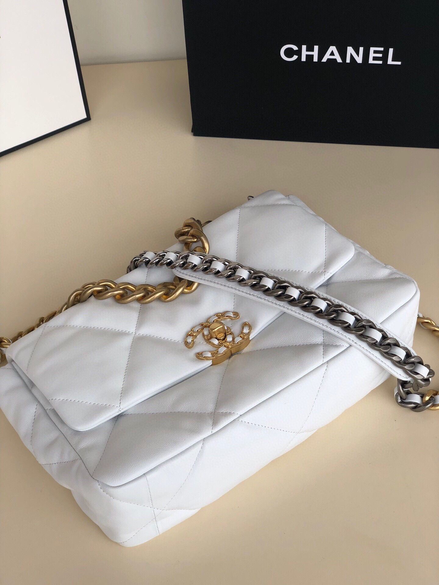 Ch*el 19 large handbag shiny leather, gold-tone, silver-tone & ruthenium-finish metal white 7.8 × 11.7 × 3.9 in